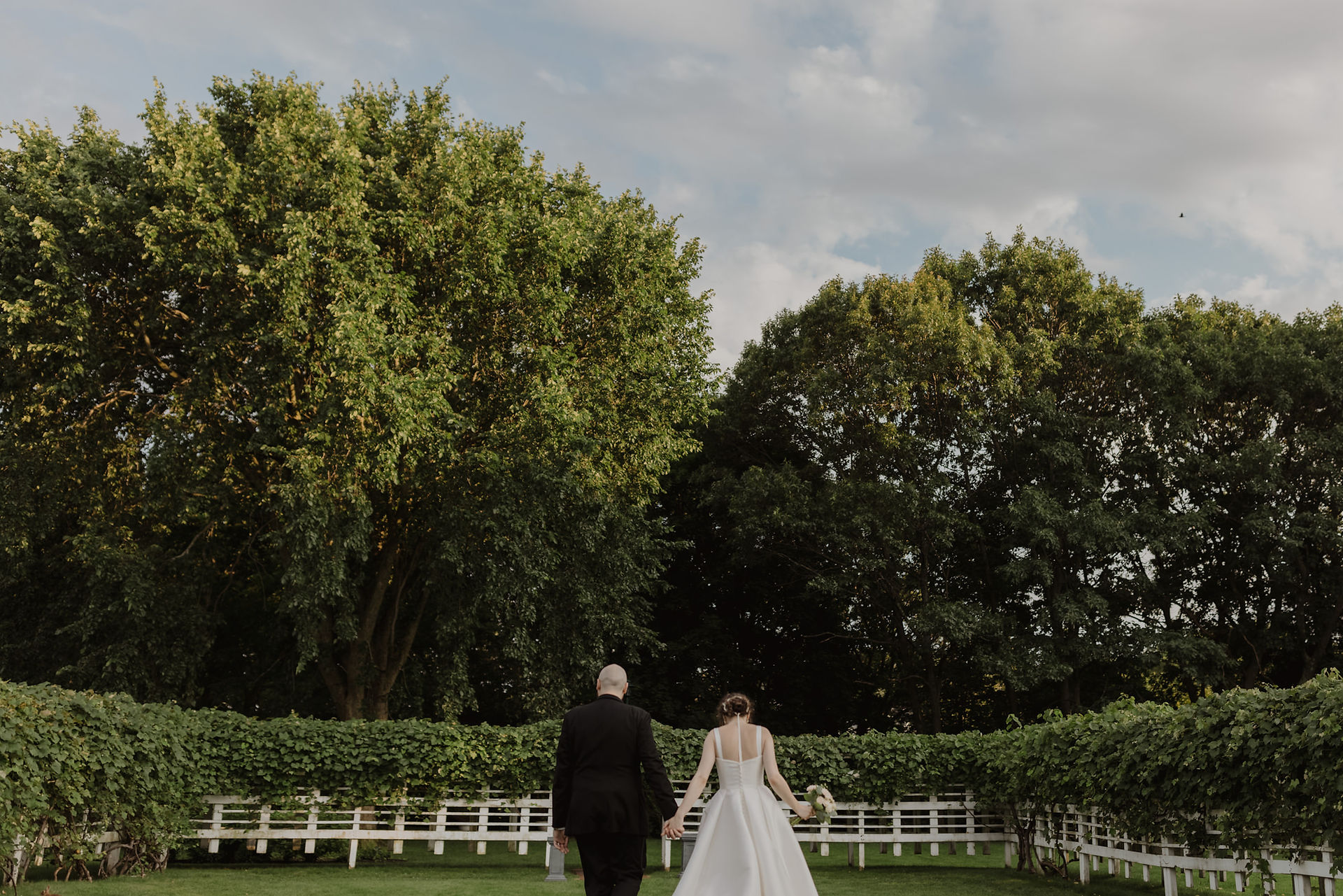 Bride and groom in grape arbor at Commander's Mansion