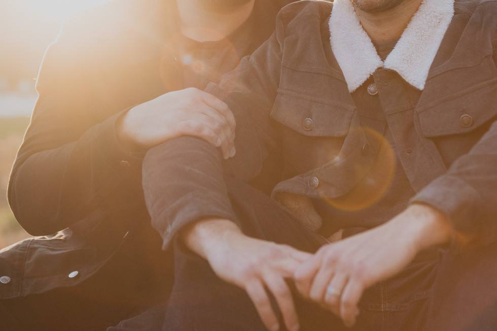 Same sex couple sitting at sunset in Arnold Arboretum Boston, Massachusetts