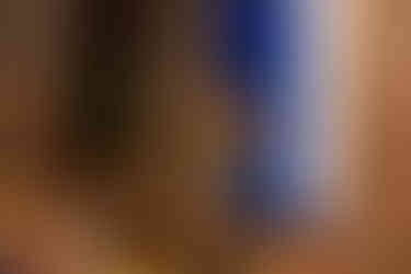 A speaker stands at the front of the room addressing seated attendees during a gathering.