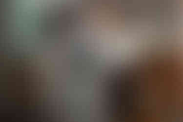 A participant listens to music through headphones while holding a paper during the event’s exhibition.