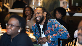 Will Jackson smiling while seated at a dinner table.