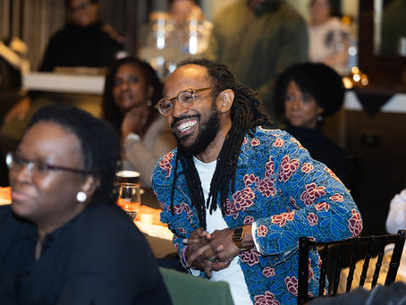 Will Jackson smiling while seated at a dinner table.