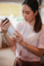 Woman carefully examining shampoo ingredients before purchase