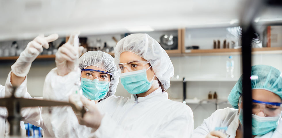 pharmacists in a sterile lab formulating a medication