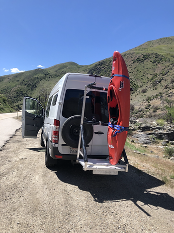 Van carrying custom rack holding both bike and a kayak