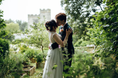 BoHo Cornwall Elopements couple embrace in the beautiful landscape gardens at Pengersick Castle, Praa Sands, Cornwall, UK