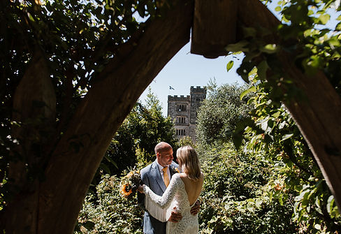 BoHo Cornwall Elopements couple under the romantic arch in the Pengersick Castle Gardens