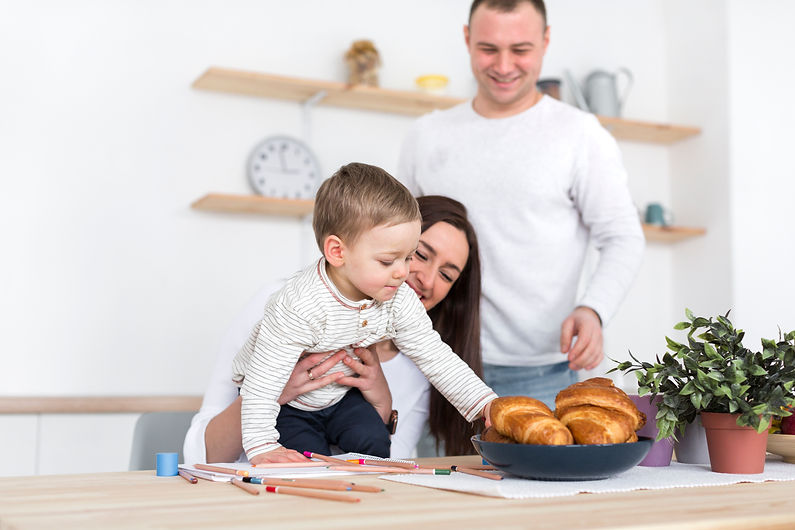 child-grabbing-croissants-with-parent-kitchen.jpg