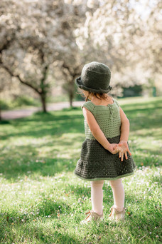 Back view of toddler with her hands clasped behind her back