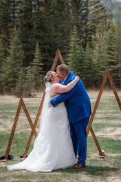 bride and groom kissing at wedding ceremony