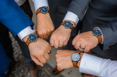 Closeup of groomsmen showing their watches