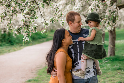 Mom, Dad and baby girl sharing a laugh together