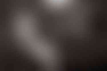 black and white closeup of groom fixing suit cuffs