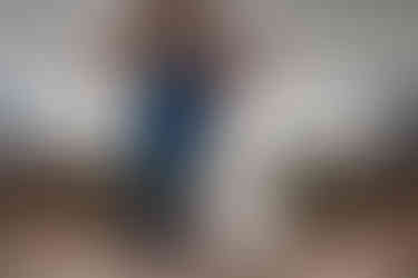 bride and groom hugging in front of Mr and Mrs wedding sign