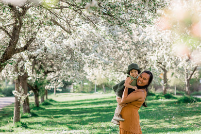 Mom holding baby girl closely on her chest