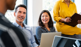 People meeting contemplating the benefits of having specialist AI capability without needing to hire a team.