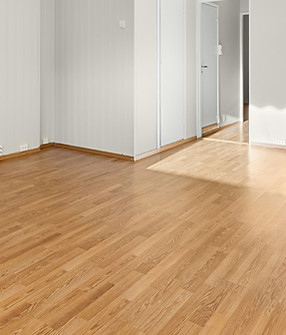 An empty room with hard wood floors and 