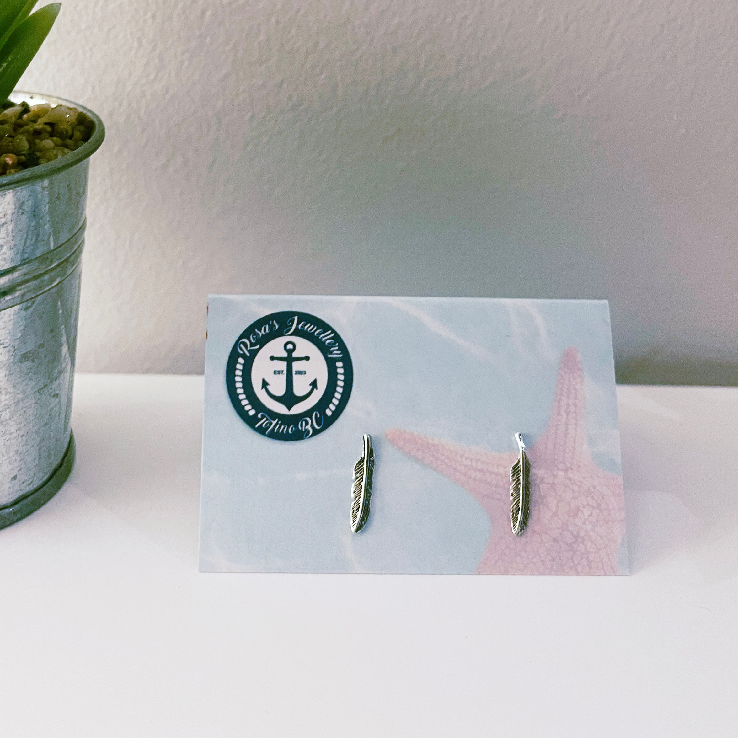 Sterling Silver stud feather earrings .