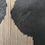 Thumbnail: Close-up of pale wood ridges against textured black surface.