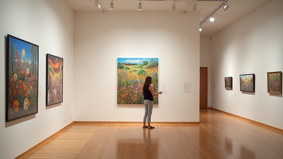 Eye-level view of the Prairie Arts Center's main gallery filled with vibrant artwork