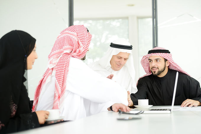 Successful Arabic business people shakin