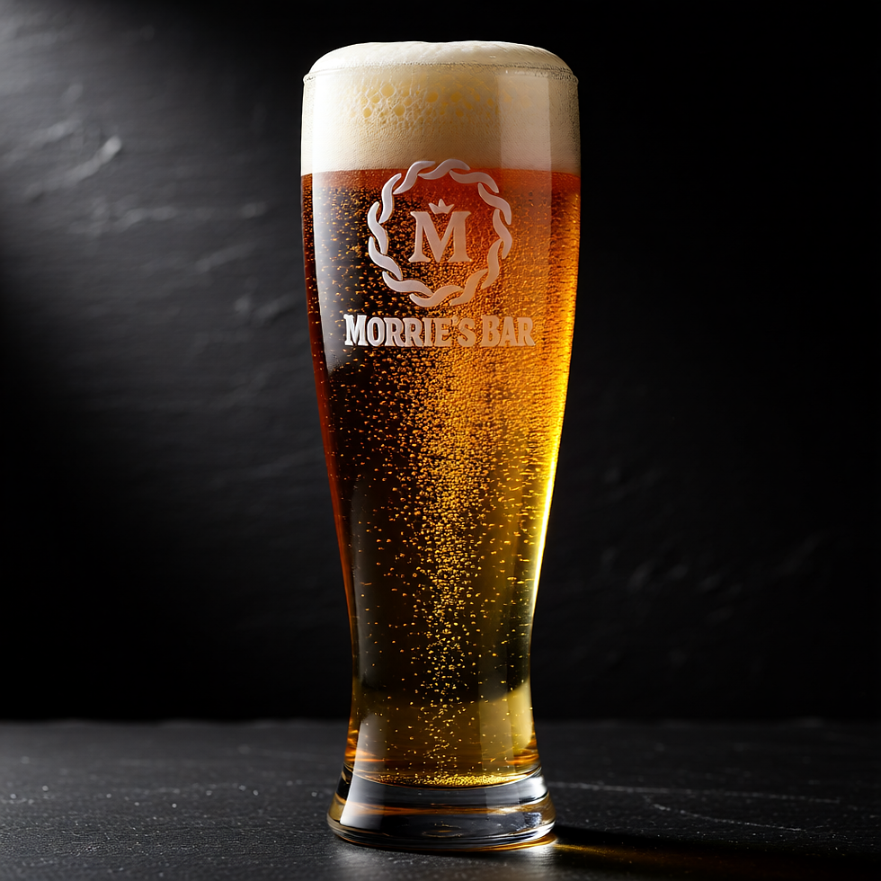 Filled pilsner glass on bar, with a massive dripping foam crown and an engraved Aurora Pils logo.