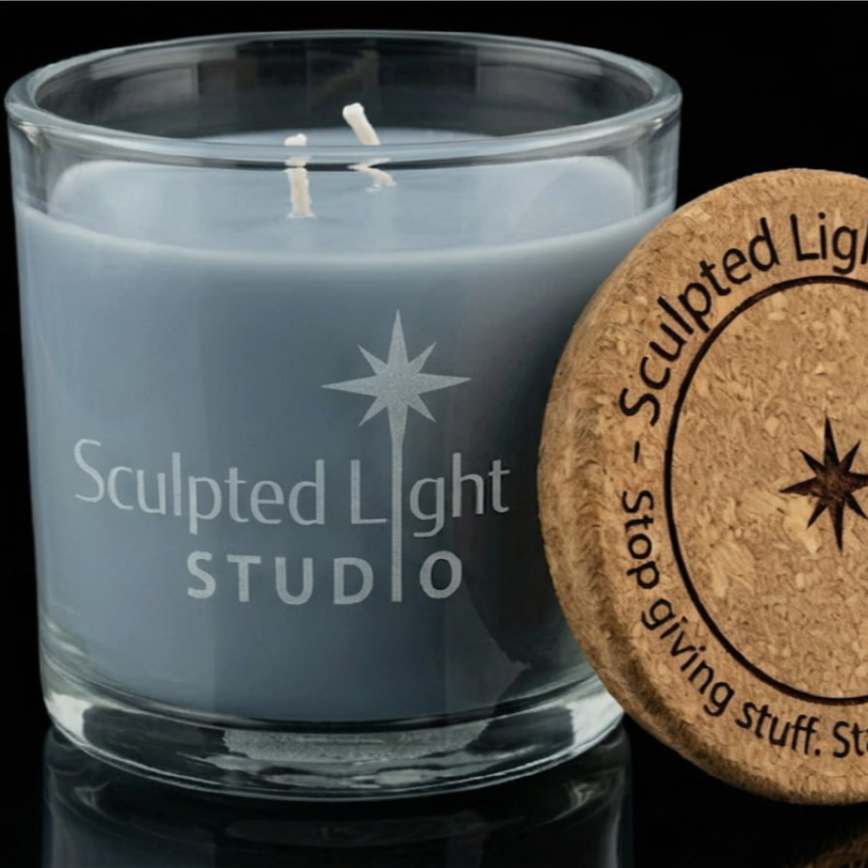 A blank, unengraved light blue Linen scented candle in a clear glass vessel with an open natural cork lid, ready to be custom