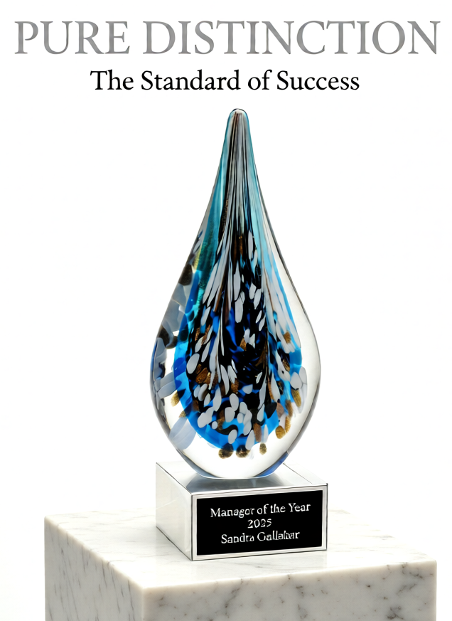 Custom multi-color teardrop art glass corporate award on a white marble base with a personalized black plate.