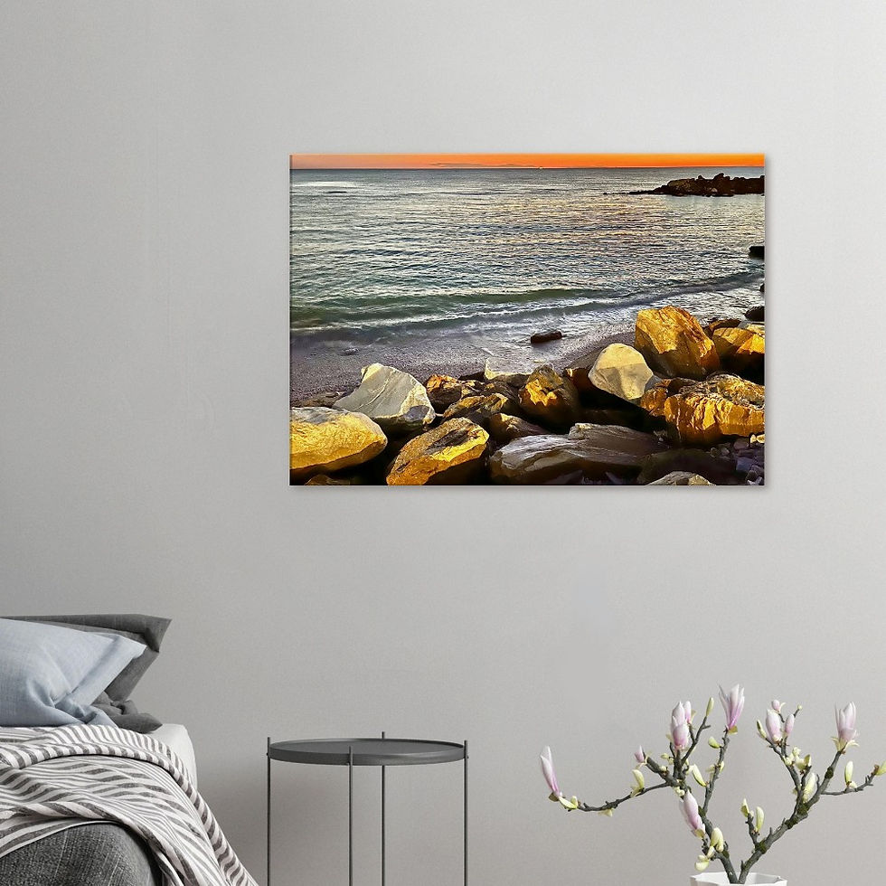 Orange sunset sky over the sea next to the rock beach Pisa, Italy