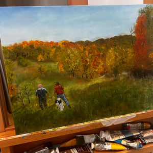 a painting of two people walking a dog with tubes of gouache on the easel