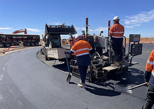 Asphalt paver and paving crew at work