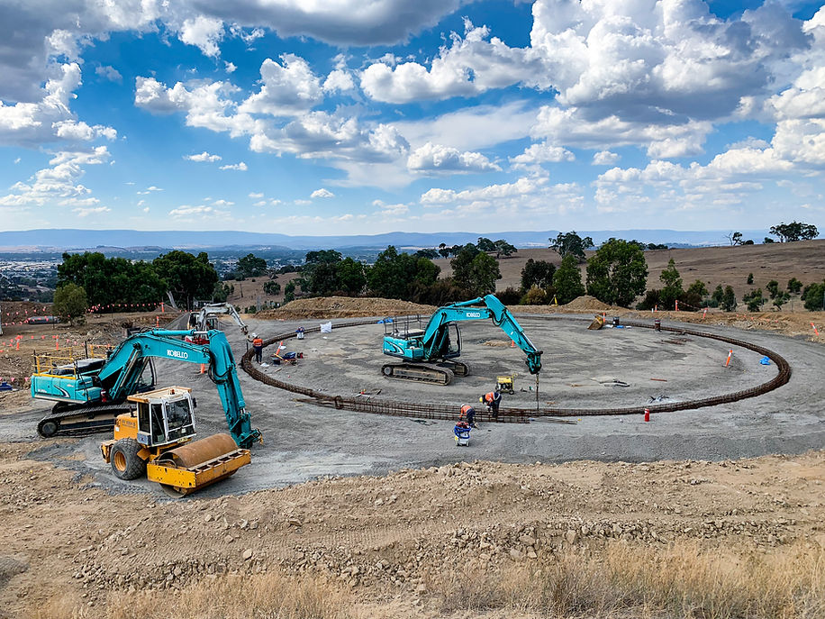 Adams Civil excavators and roller building a circular tank foundation