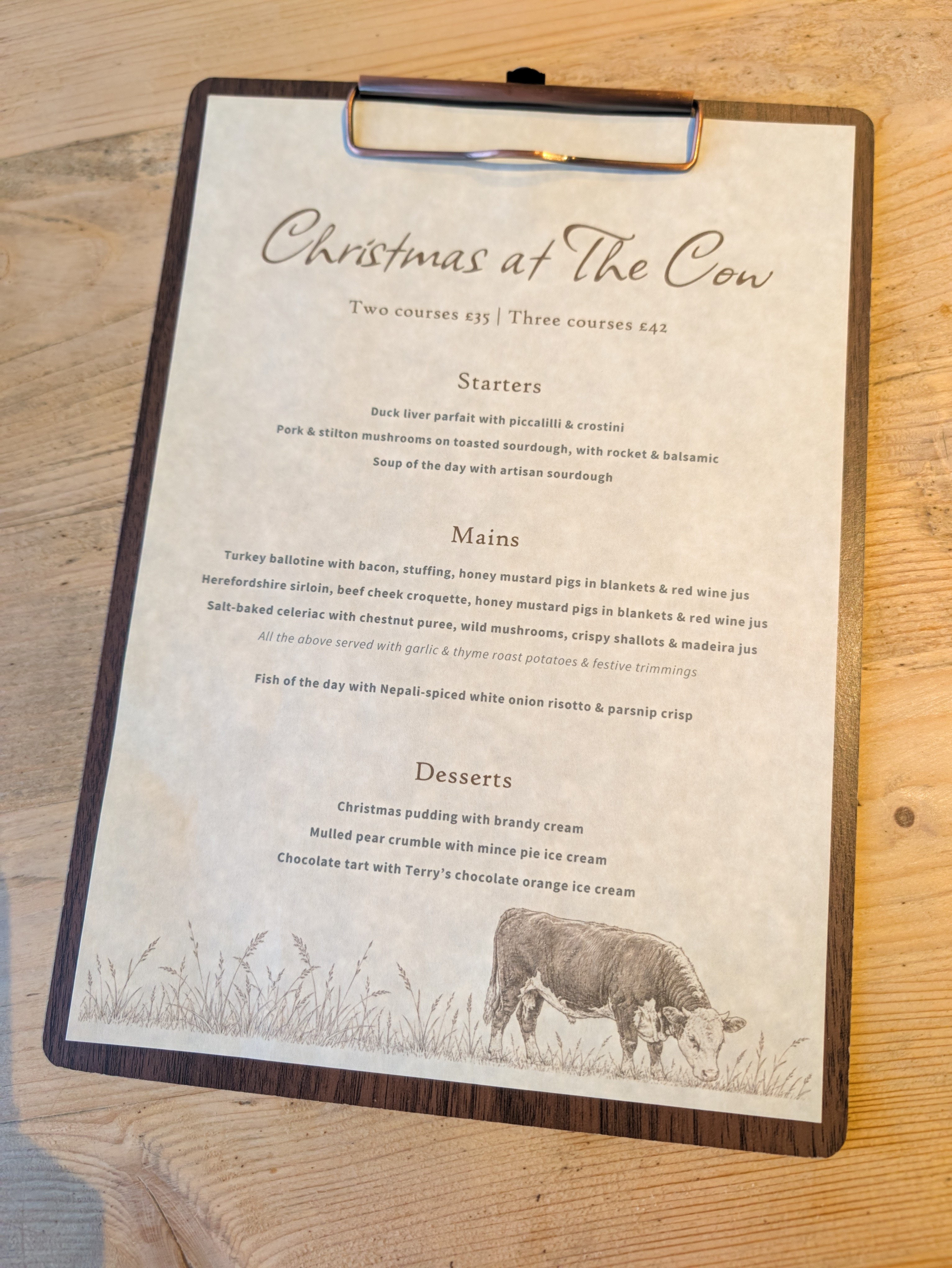Photograph of the set menu with sections for Starters, Mains, and Desserts. The menu options are included in the text below.