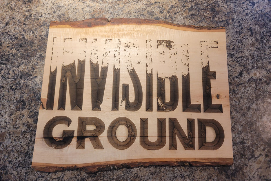 Wooden sign with INVISIBLE GROUND