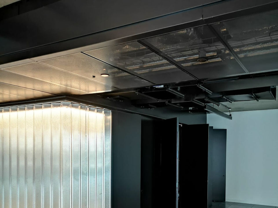 cladding, blackened steel, perforated serves spine cover screen
