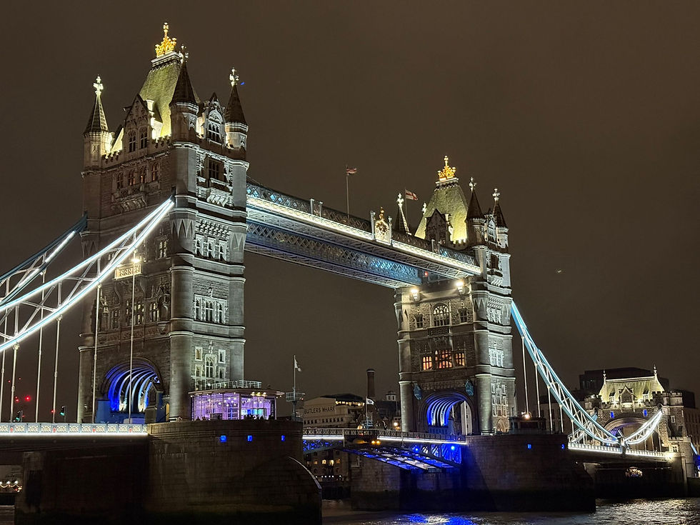 Tower Bridge London at night lit up with multi-coloured lights