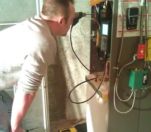 Tom working on a older style combi boiler and tuning for efficient operation