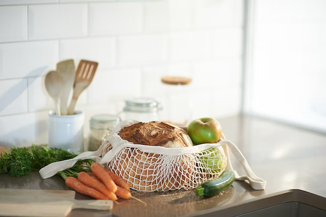 Cotton mesh grocery bag filled with fresh produce