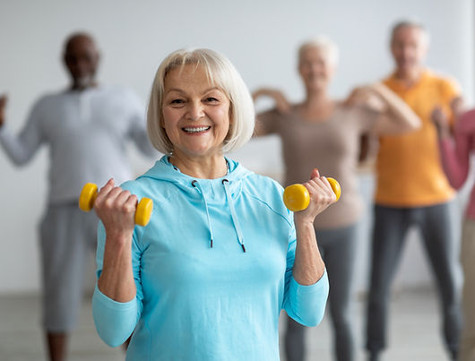 Multiracial group of senior people in sportswear doing strength building fitness exercises