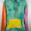 Thumbnail: Multicolor hoodie-teal body, pink sleeve, orange sleeve and yellow pocket.  No graphic just bleach splatters 