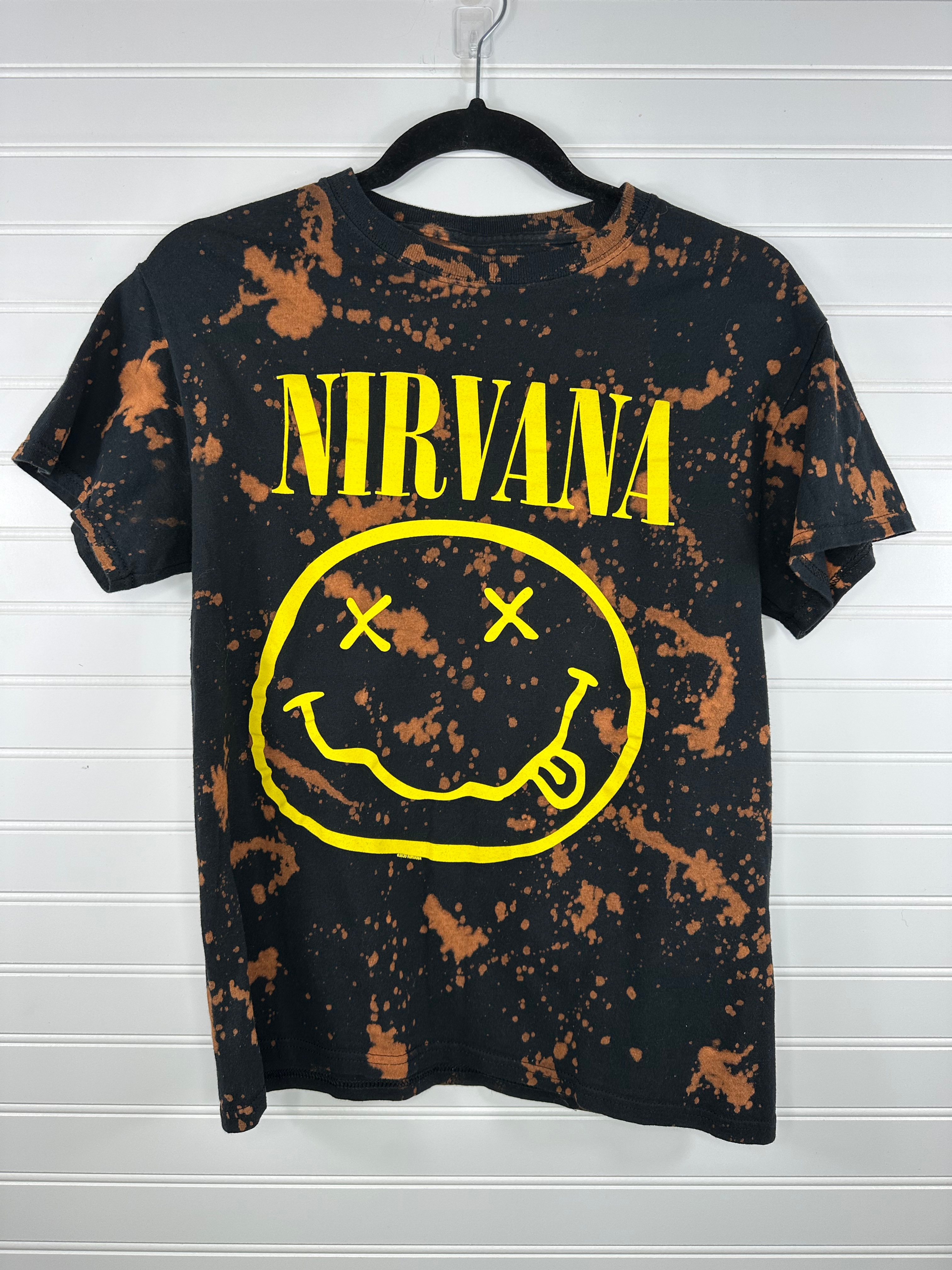 Nirvana with big smiley face in yellow on black shirt with bleach splatter 