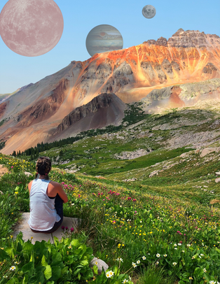 A girl sits in a field of wild flowers and deep green grasses at the base of a towering, red rock mountain. Warm hues of orange iron rust create depth in the crevasses of the mountain. The girl gazes into a blue dawn sky, at large cosmic planets hanging in the distance. 