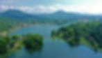 lake-junaluska-aerial-photo-with-lush-green-trees-and-clear-blue-water-e1656080606531.jpg