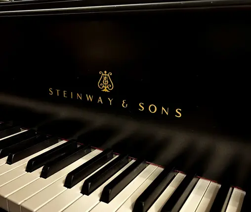 Close-up of Steinway & Sons fallboard logo on Model A Grand Piano at Rockafellow Piano in San Antonio, Texas.
