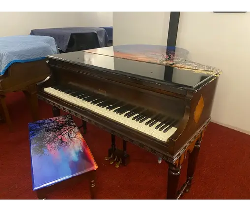 Keyboard view of Everett Baby Grand Piano with warm wood finish at Rockafellow Piano in San Antonio, Texas.