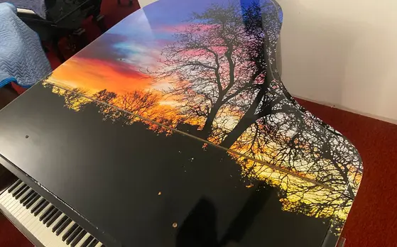 Close-up of Everett Baby Grand Piano custom sunset lid artwork showing vibrant colors at Rockafellow Piano in San Antonio, Texas.