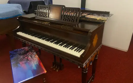 Music rack view of Everett Baby Grand Piano with carved detailing at Rockafellow Piano in San Antonio, Texas.