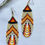 Thumbnail: Cream, Black, Red, Orange and Yellow Loop Beaded Earrings