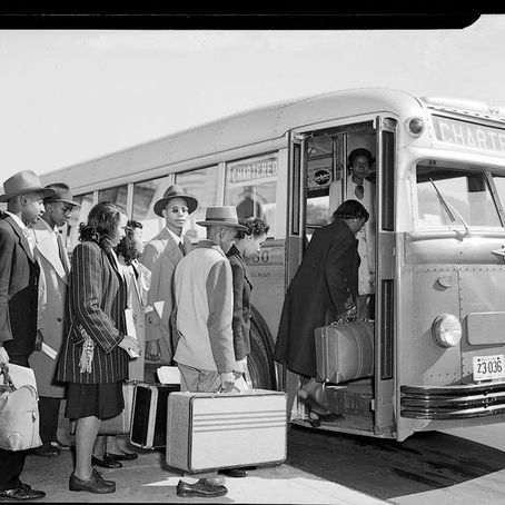 People in suits and hats board a chartered bus with luggage. The mood is orderly and formal, set in a black and white urban environment.