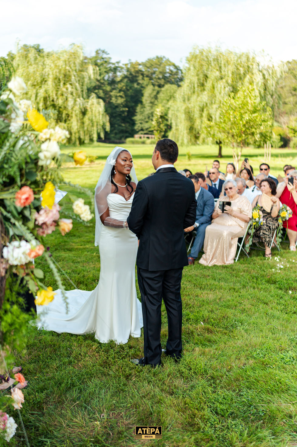 Bride and groom at outdoor wedding ceremony.
